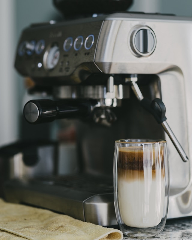 Lineup of budget and premium espresso machines on a modern kitchen counter